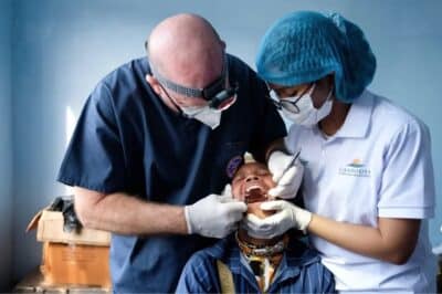 Dr. Stewart Powers examines a patient on a recent Cambodia Christian Ministries medical campaign. (Photo by Audrey Jackson)